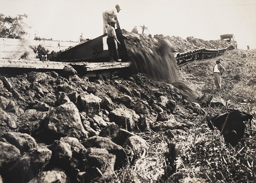 Lidgerwood unloader plow blade sweeps spoil from the flat cars.
View in Digital Collection»