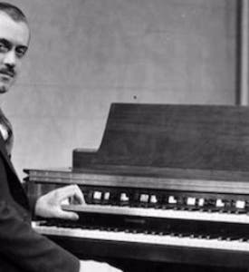 Laurens Hammond seated at a Hammond organ (Ouramericannetwork.org)