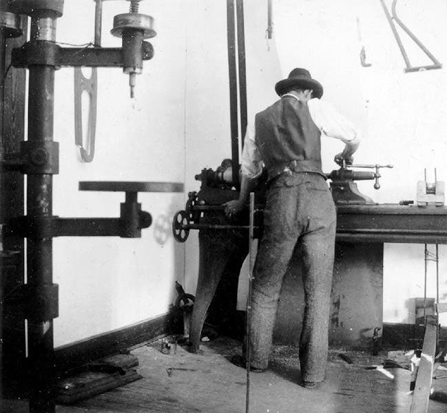 The drill press and lathe in the back of the Wright brothers' bicycle shop in Dayton, Ohio, with Wilbur at the lathe; this is where Charlie Taylor built the engine for the Flyer; period photograph (wright-brothers.org)