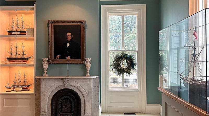 Interior of the Captain Nathaniel B. Palmer House, with Palmer’s portrait over the mantle, and several ship models in evidence of vessels that Palmer sailed, commanded, or designed (historicstonington.org)