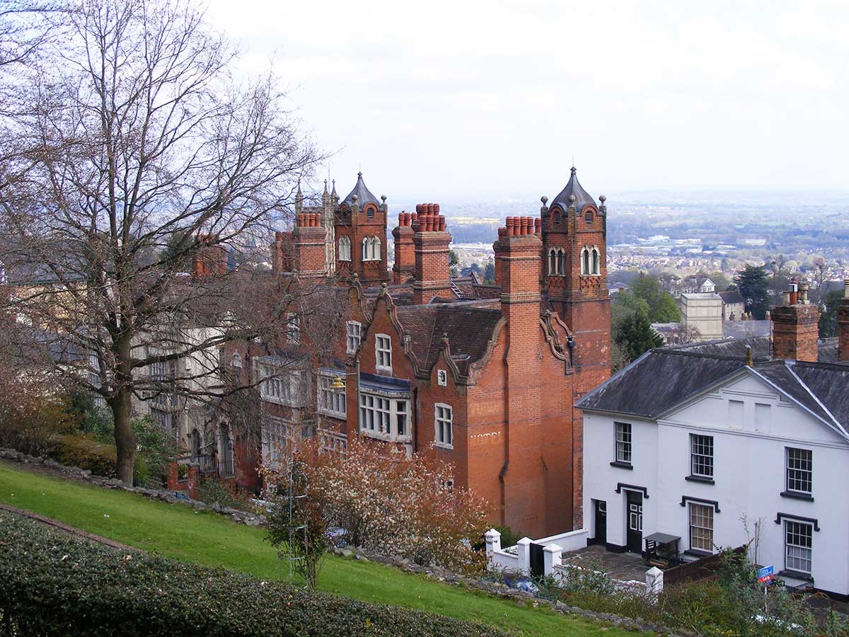 Tudor House (brick) and Holyrood House (behind the tree at left) in Malvern, two buildings where James Gully administered his water cures, now converted to apartments, recent photograph (the-malvern-hills.uk)