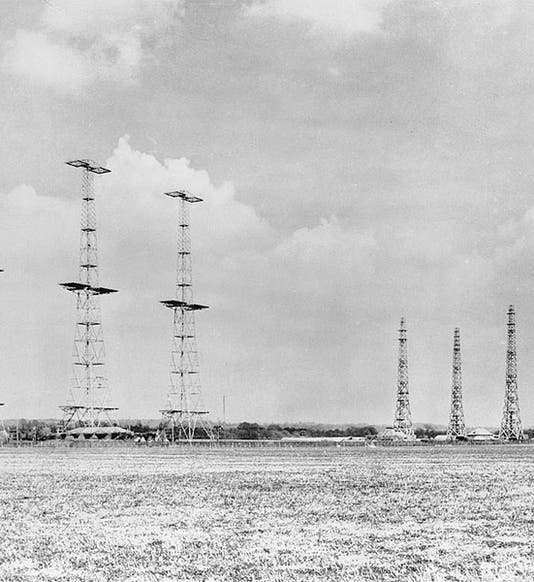 Chain Home radar installation at Poling, Sussex, photograph, 1945.  The transmitting antennas were slung between the tall towers at left; the receiving antenna towers are at right (Wikimedia commons)