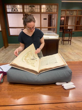 Photo of Linda Hall Library fellow Michele Pflug working in the History of Science Reading Room