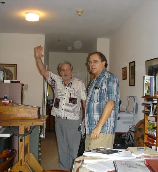Photograph taken at an unspecified Gathering 4 Gardner meeting, probably in the 2010s, with Jeremiah Farrell at center with his arm raised. Jim Gardner, Martin Gardner’s son, is on the right (gathering4gardner.org)