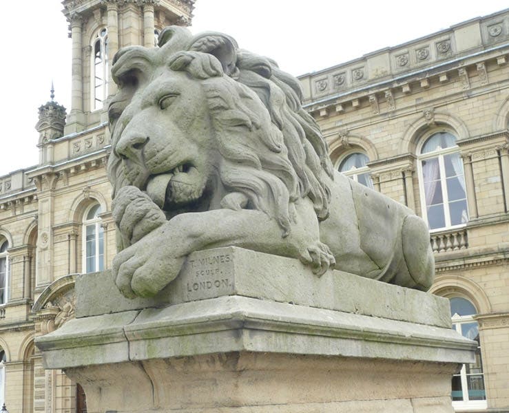 Close-up view of Peace, another Saltaire lion, with name of sculptor Thomas Milnes on the base, 1869, Saltaire, West Yorkshire (victorianweb.org)