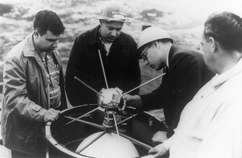 Vanguard 1 or 1A satellite being installed on top of a Vanguard rocket by a team of Naval Research Lab engineers, 1957 or 1958 (Wikimedia commons)
