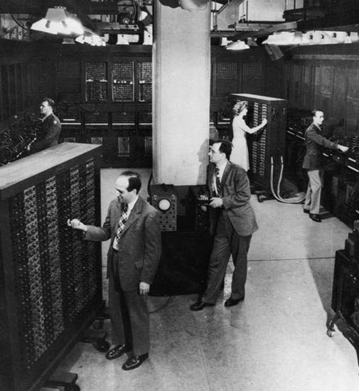 ENIAC at the Moore School; J. Presper Eckert is left foreground, John Mauchly is just to his right; photograph, ca 1946, University of Pennsylvania Archives (seas.upenn.edu)