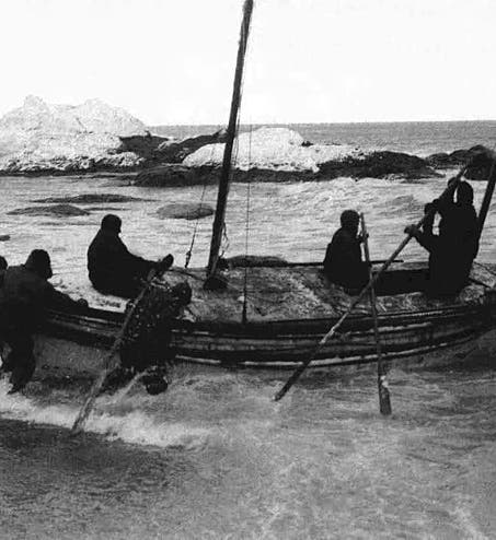 The launch of the <i>James Caird</i> from Elephant Island, Apr. 24, 1916, glass plate photograph by Frank Hurley (Wikipedia)