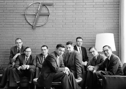 Publicity photograph featuring the “traitorous eight” researchers who left Shockley Semiconductor Laboratory in 1957 to establish Fairchild Semiconductor. From left to right: Gordon Moore, Sheldon Roberts, Eugene Kleiner, Robert Noyce, Victor Grinich, Julius Blank, Jean Hoerni, and Jay Last. (PBS/Intel)