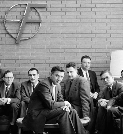 Publicity photograph featuring the “traitorous eight” researchers who left Shockley Semiconductor Laboratory in 1957 to establish Fairchild Semiconductor. From left to right: Gordon Moore, Sheldon Roberts, Eugene Kleiner, Robert Noyce, Victor Grinich, Julius Blank, Jean Hoerni, and Jay Last. (PBS/Intel)