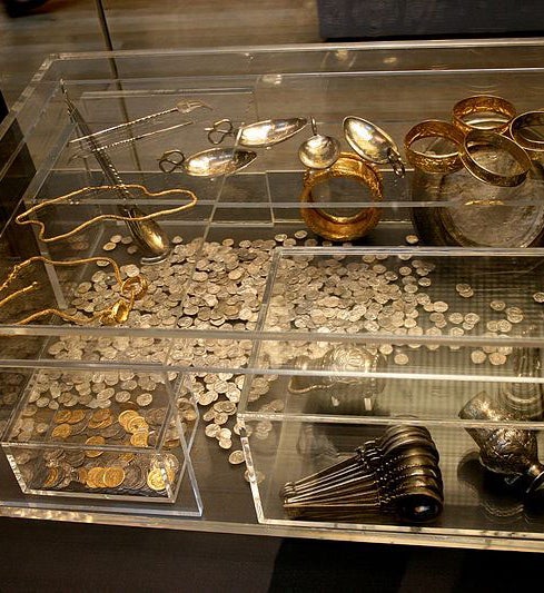 Part of the Hoxne hoard on display; the original oak box, long decayed, is replicated in acrylic (Wikimedia Commons)