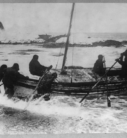 Launch of the James Caird from Elephant Island, Apr. 24, 1916, photo by Frank Hurley; Harry McNish is one of the seven men here (six would end up on board), Library of Congress (loc.gov)