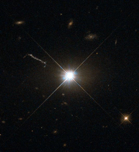 This image from Hubble’s Wide Field and Planetary Camera 2 (WFPC2) is likely the best of ancient and brilliant quasar 3C 273, which resides in a giant elliptical galaxy in the constellation of Virgo (The Virgin). Its light has taken some 2.5 billion years to reach us. Despite this great distance, it is still one of the closest quasars to our home. It was the first quasar ever to be identified, and was discovered in the early 1960s by astronomer Allan Sandage. The term quasar is an abbreviation of the phrase “quasi-stellar radio source”, as they appear to be star-like on the sky. In fact, quasars are the intensely powerful centres of distant, active galaxies, powered by a huge disc of particles surrounding a supermassive black hole. As material from this disc falls inwards, some quasars — including 3C 273  — have been observed to fire off super-fast jets into the surrounding space. In this picture, one of these jets appears as a cloudy streak, measuring some 200 000 light-years in length. Quasars are capable of emitting hundreds or even thousands of times the entire energy output of our galaxy, making them some of the most luminous and energetic objects in the entire Universe. Of these very bright objects, 3C 273 is the brightest in our skies. If it was located 30 light-years from our own planet — roughly seven times the distance between Earth and Proxima Centauri, the nearest star to us after the Sun — it would still appear as bright as the Sun in the sky.   WFPC2 was installed on Hubble during shuttle mission STS-61. It is the size of a small piano and was capable of seeing images in the visible, near-ultraviolet, and near-infrared parts of the spectrum.