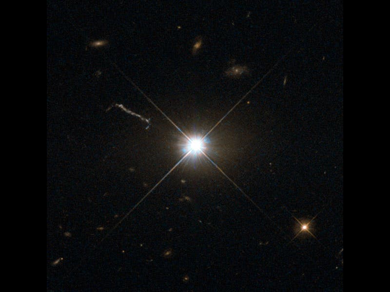 This image from Hubble’s Wide Field and Planetary Camera 2 (WFPC2) is likely the best of ancient and brilliant quasar 3C 273, which resides in a giant elliptical galaxy in the constellation of Virgo (The Virgin). Its light has taken some 2.5 billion years to reach us. Despite this great distance, it is still one of the closest quasars to our home. It was the first quasar ever to be identified, and was discovered in the early 1960s by astronomer Allan Sandage. The term quasar is an abbreviation of the phrase “quasi-stellar radio source”, as they appear to be star-like on the sky. In fact, quasars are the intensely powerful centres of distant, active galaxies, powered by a huge disc of particles surrounding a supermassive black hole. As material from this disc falls inwards, some quasars — including 3C 273  — have been observed to fire off super-fast jets into the surrounding space. In this picture, one of these jets appears as a cloudy streak, measuring some 200 000 light-years in length. Quasars are capable of emitting hundreds or even thousands of times the entire energy output of our galaxy, making them some of the most luminous and energetic objects in the entire Universe. Of these very bright objects, 3C 273 is the brightest in our skies. If it was located 30 light-years from our own planet — roughly seven times the distance between Earth and Proxima Centauri, the nearest star to us after the Sun — it would still appear as bright as the Sun in the sky.   WFPC2 was installed on Hubble during shuttle mission STS-61. It is the size of a small piano and was capable of seeing images in the visible, near-ultraviolet, and near-infrared parts of the spectrum.