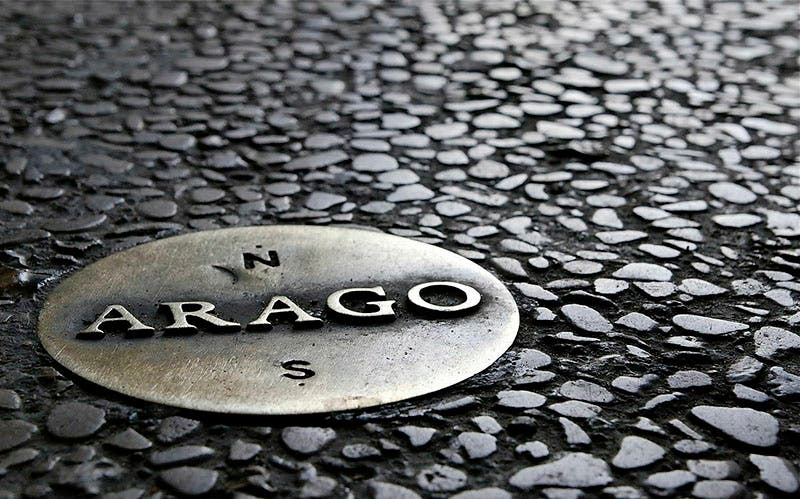 One of the 135 medallions commemorating François Arago laid along the Paris meridian, designed by Jan Dibbets, 1994 (atlasobscura.com)
