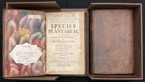 The two volumes of Species plantarum, by Carl Linnaeus, 1753, nestled in their clamshell box, with volume 1 opened up, and the signatures of three former owners on the pastedown at left (Linda Hall Library)