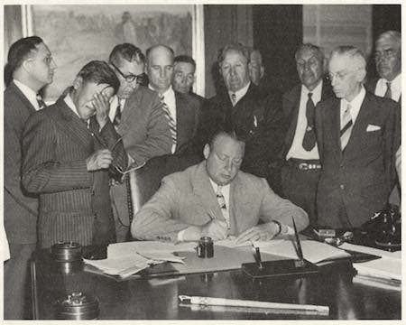 George Gillette, a council member of the Three Affiliated Tribes, becomes emotional as Secretary of the Interior Julius Krug signs the contract in 1948 transferring the tribes’ land to the government for the Garrison Dam project. Image source: Associated Press photo in Lambrecht, Bill. Big Muddy Blues: True Tales and Twisted Politics Along Lewis and Clark’s Missouri River. St. Martin’s Press, 2005, p. 171. View Source