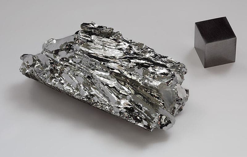 Molybdenum crystalline fragment and cube, an element first isolated by Peter Jacob Hjelm in 1781 (Wikimedia commons)