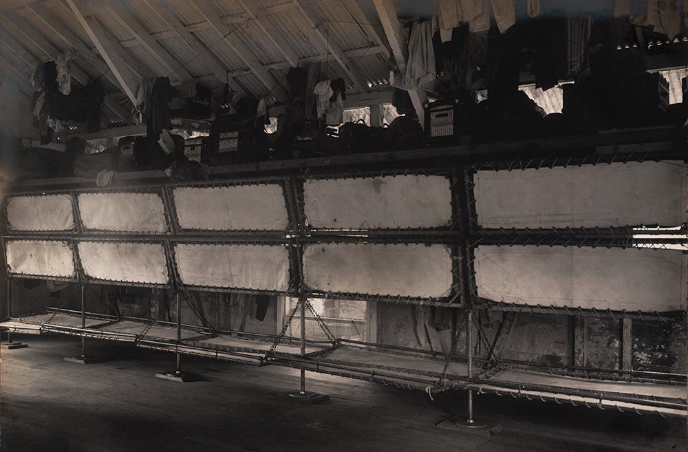 Sleeping quarters for unskilled workers.
In barracks provided for unmarried silver payroll employees, workers slept on racks of cots with no private storage space for their belongings. View in Digital Collection »