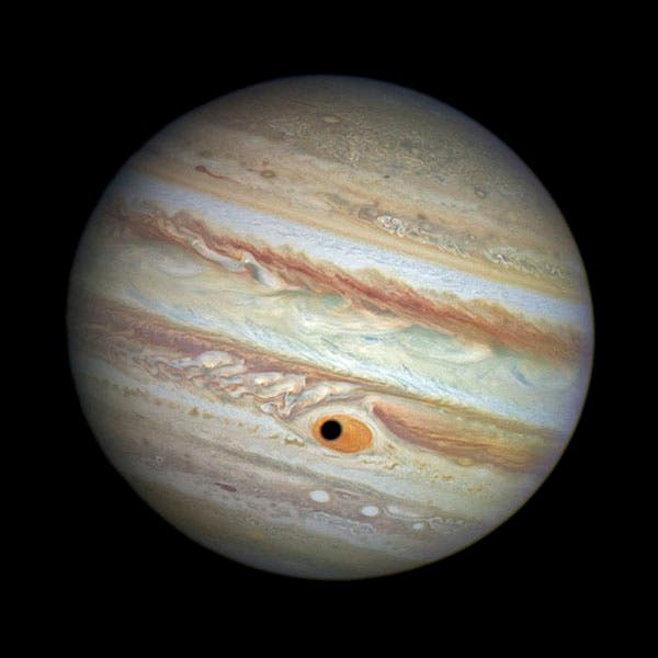 The shadow of Jupiter’s moon Ganymede passing over the Great Red Spot, image from the Hubble Space Telescope, 2014 (cdn.spacetelescope.org)