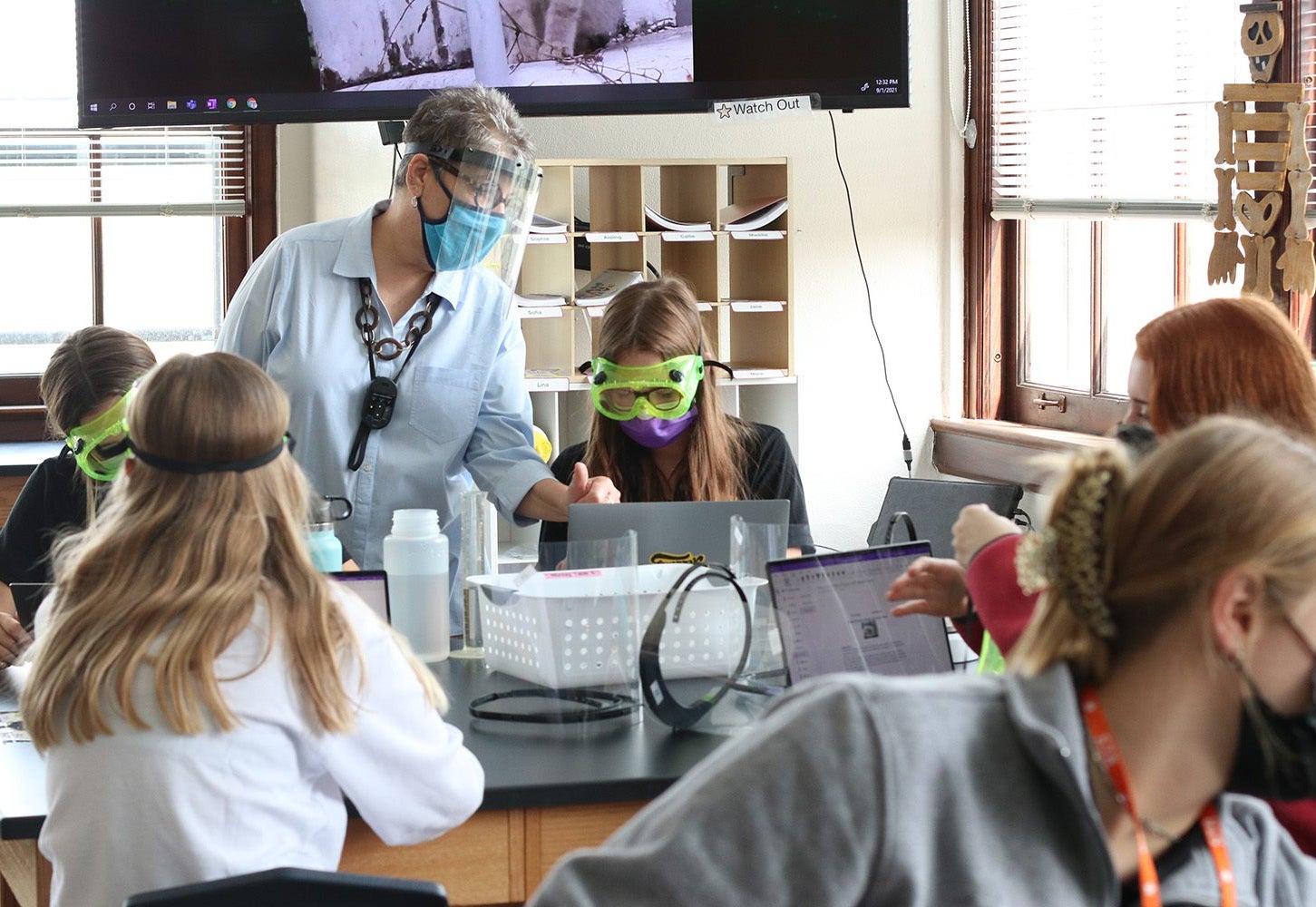 Kids and Teacher with goggles and computers