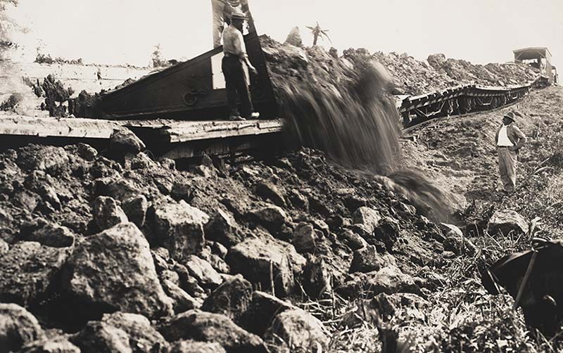 Workers close the spillway gates of the Gatún Dam, enabling Gatún Lake to fill to its operational height of 85 feet above sea level.