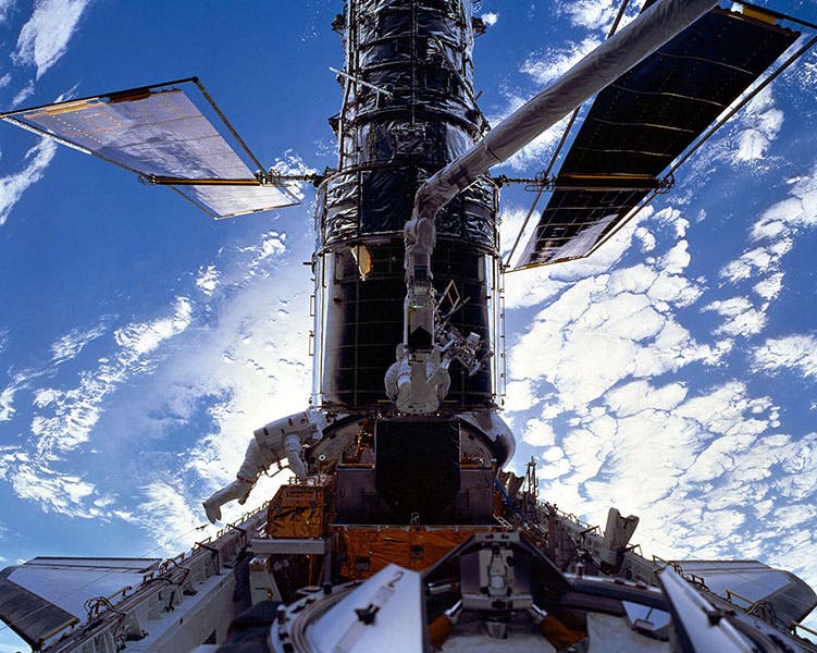 HST being serviced by the crew of the Discovery, on service mission 3A (STS-103), December 1999 (cdn.spacetelescope.org)