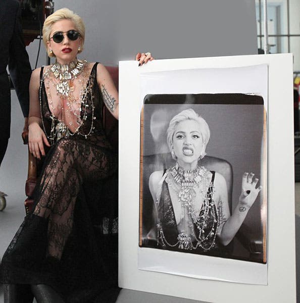 Lady Gaga poses with her Polaroid portrait at the MIT Museum in 2010. (MIT Alumni Association)