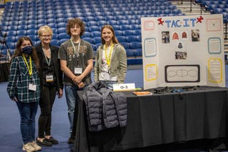 Peggy Kelly with students at the Kansas City Invention Convention