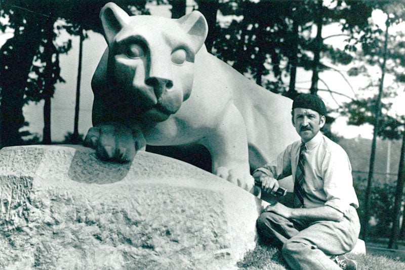 Heinz Warneke posing with this just-completed limestone sculpture, Nittany Lion, ca 1942, Penn State campus, University Park, Penn. (collegian.psu.edu)