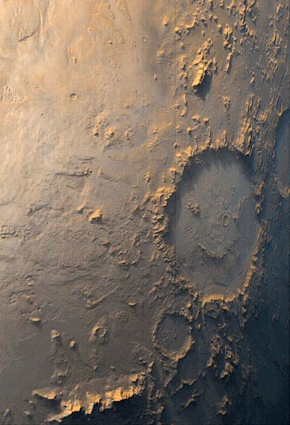 Galle crater on Mars, also known as the “Happy-Face” crater, photographed by the orbiting Mars Global Surveyor, 1999 (Wikimedia commons)