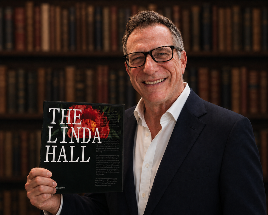 President Eric Dorfman holding The Linda Hall: A Visual History 80th anniversary book