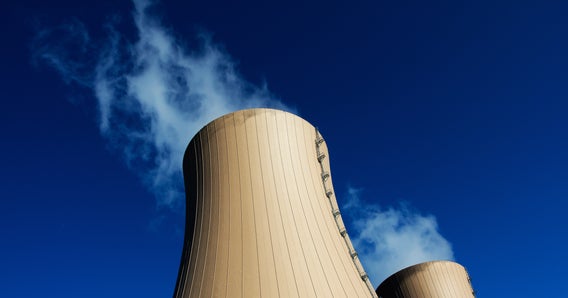 Image of cooling towers of nuclear power plant against blue sky