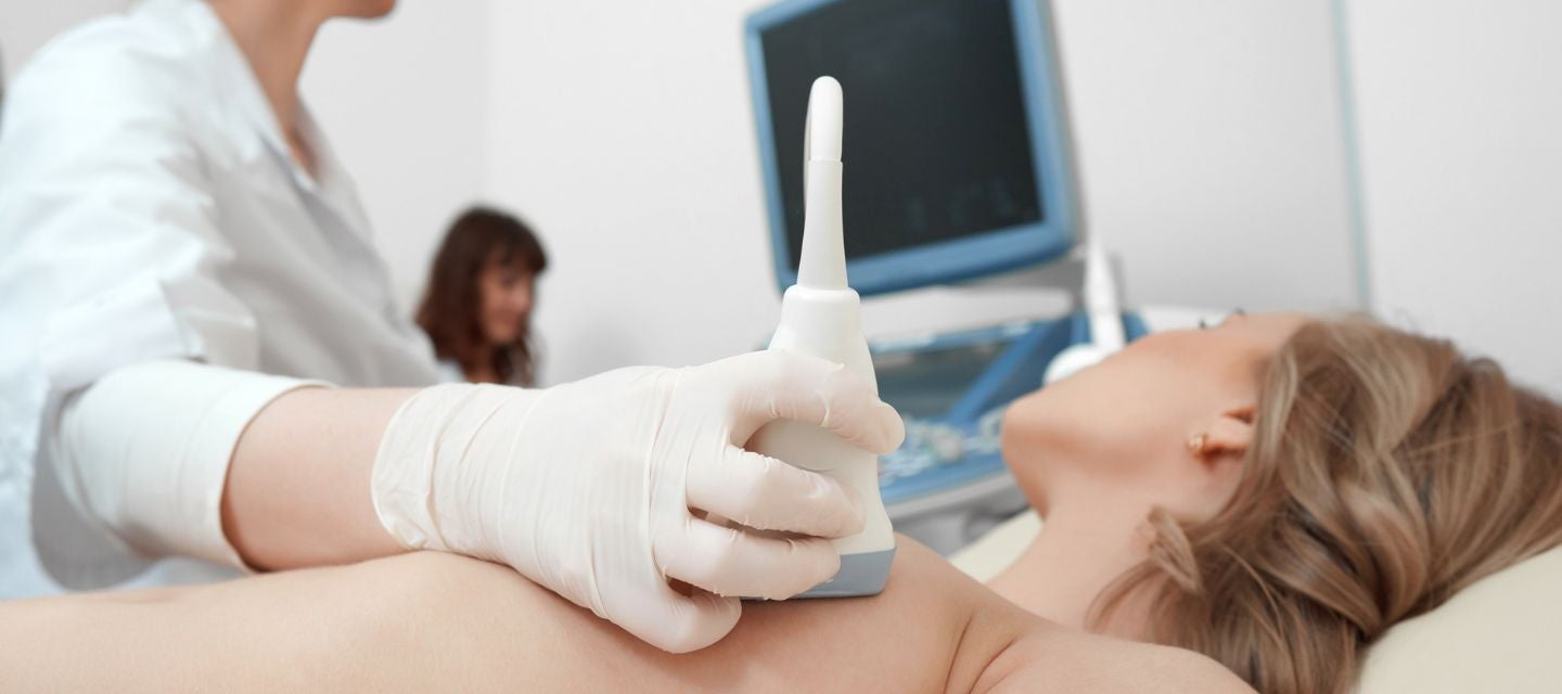 Image of woman having a breast ultrasound