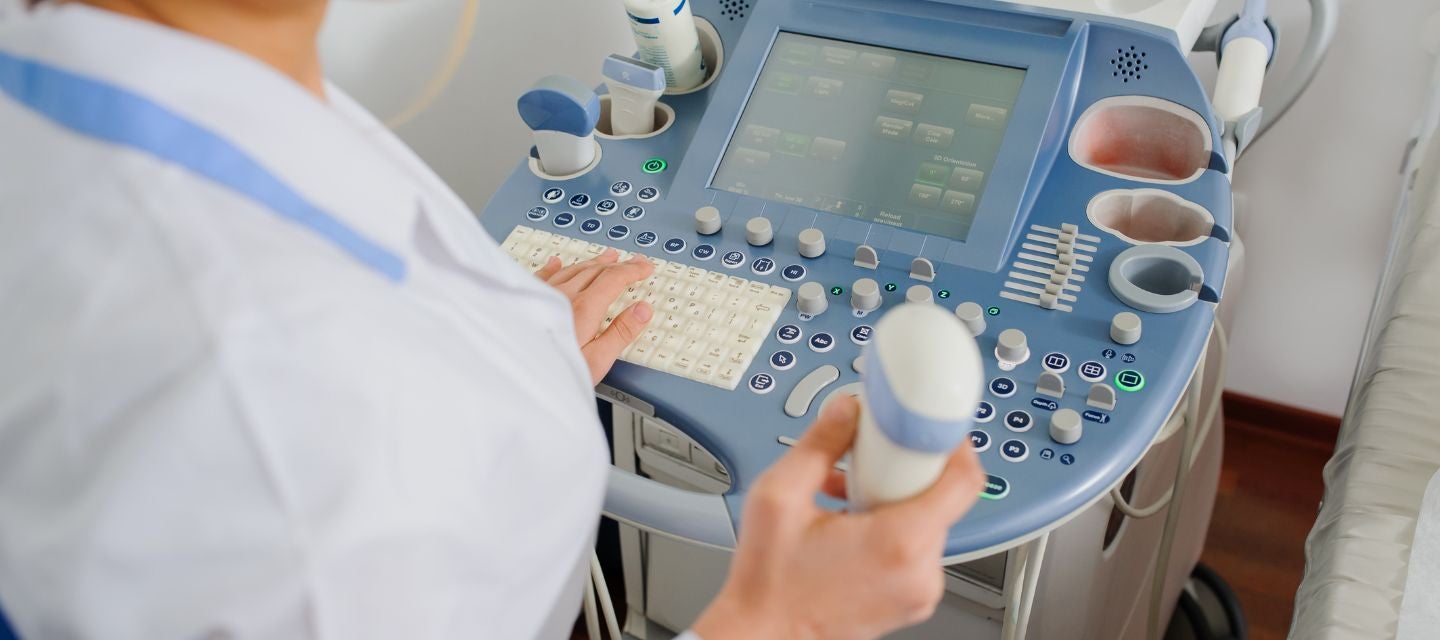 ultrasound technician close up with ultrasound machine