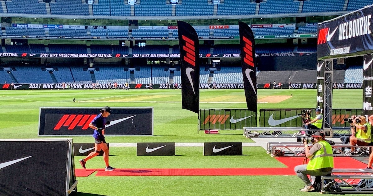 Former ‘non-runner’ Tony Duan crossing the line at the Melbourne Marathon in 2021.