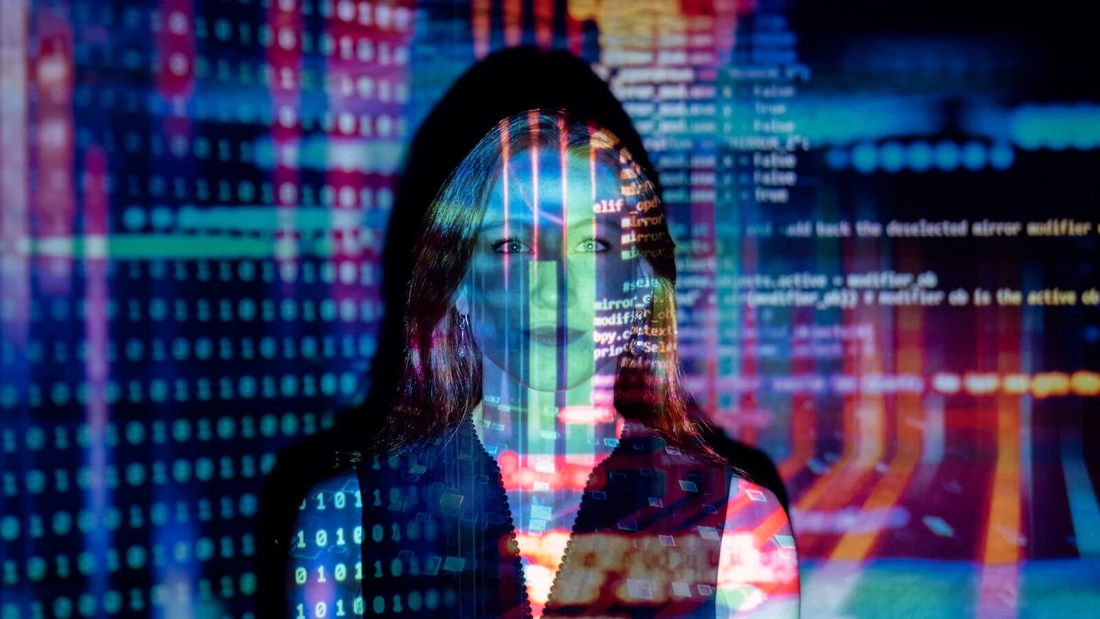 Code projected over a woman's face