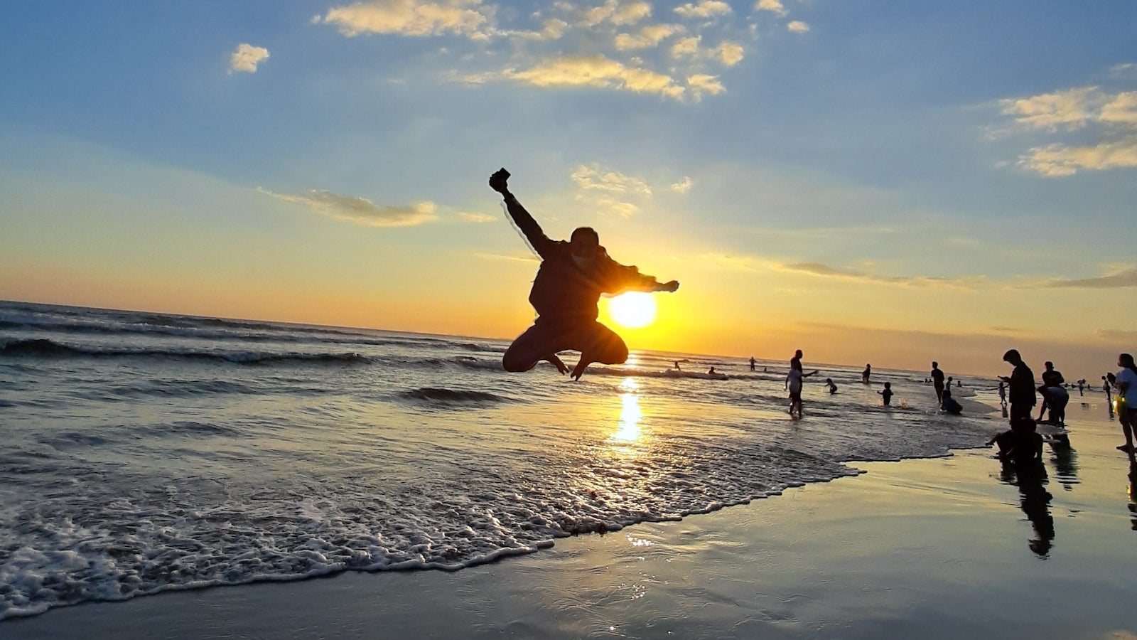 Neil's jumping during his run on the beach in Bali