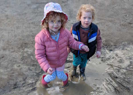 Ivy and Arlo in the puddle