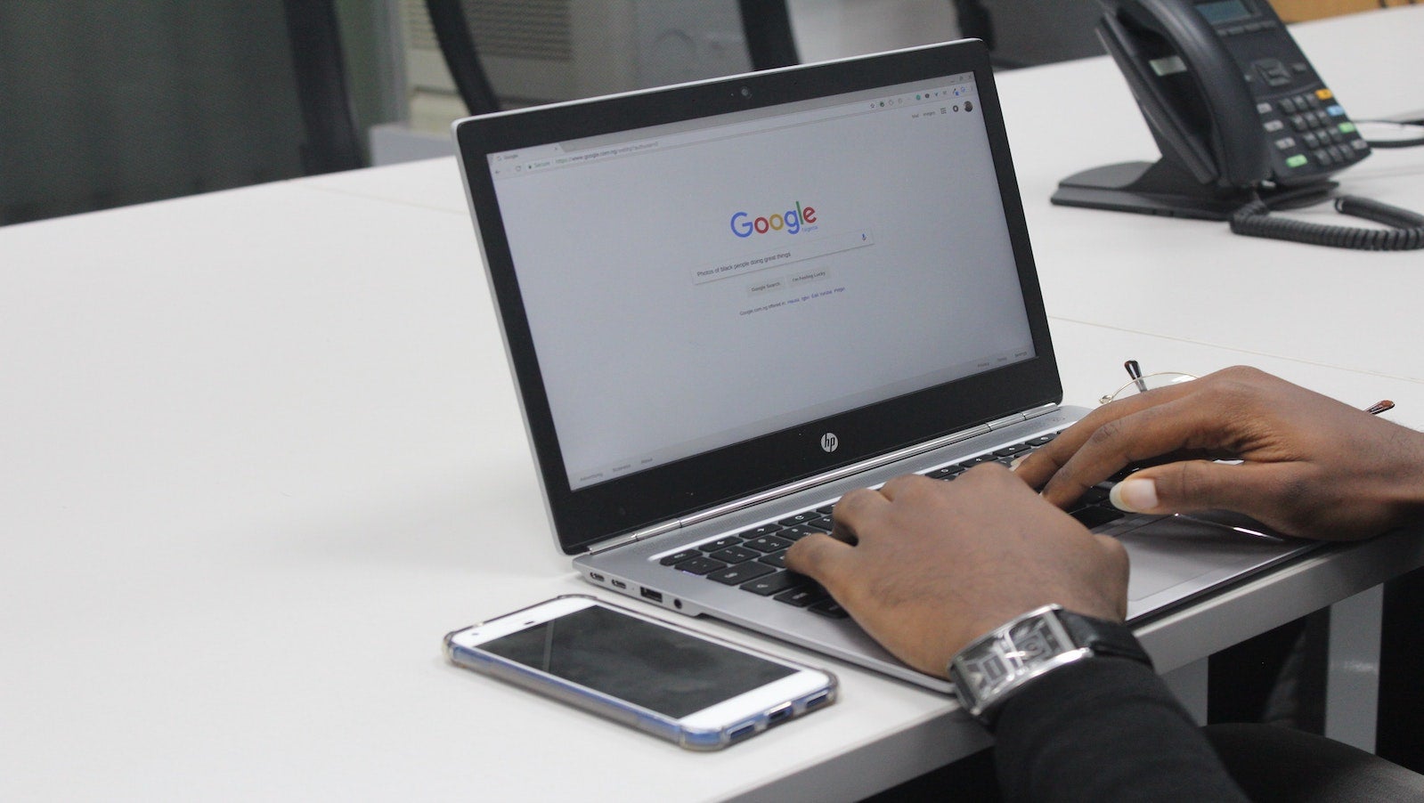 Picture of a laptop on a table with a Google search engine on the screen, demonstrating SEO copywriting ideation.