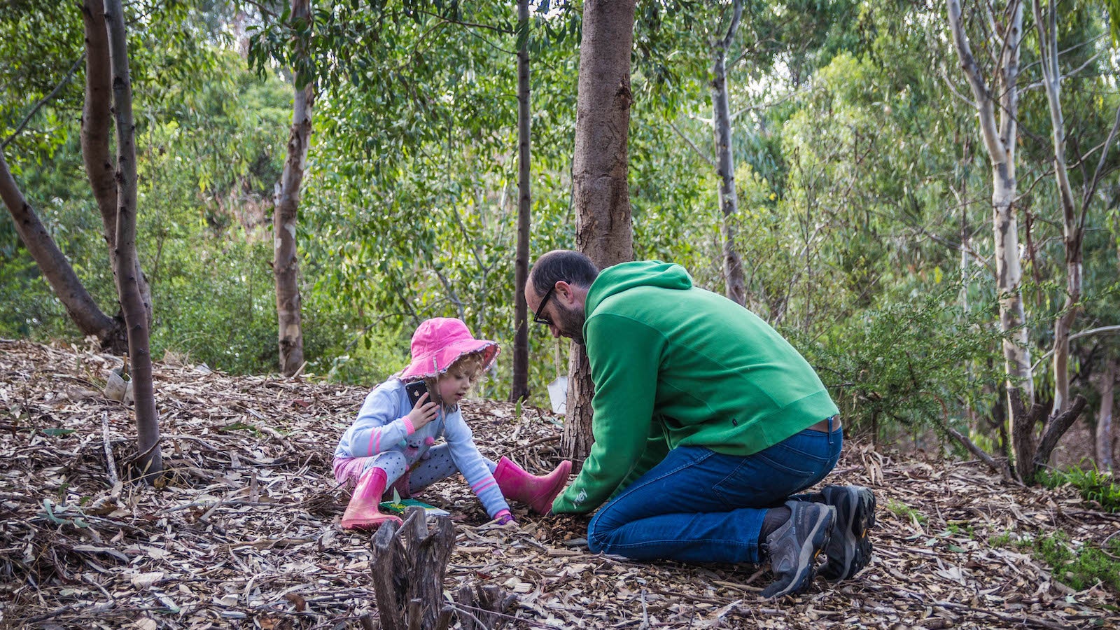 Father and daughter planting trees