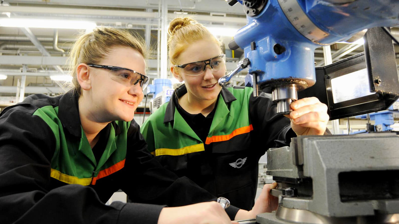 Two students using a piece of machinary