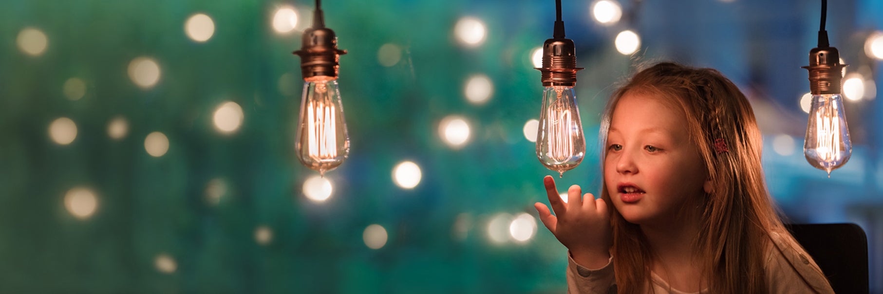 Young child looking at lightbulb