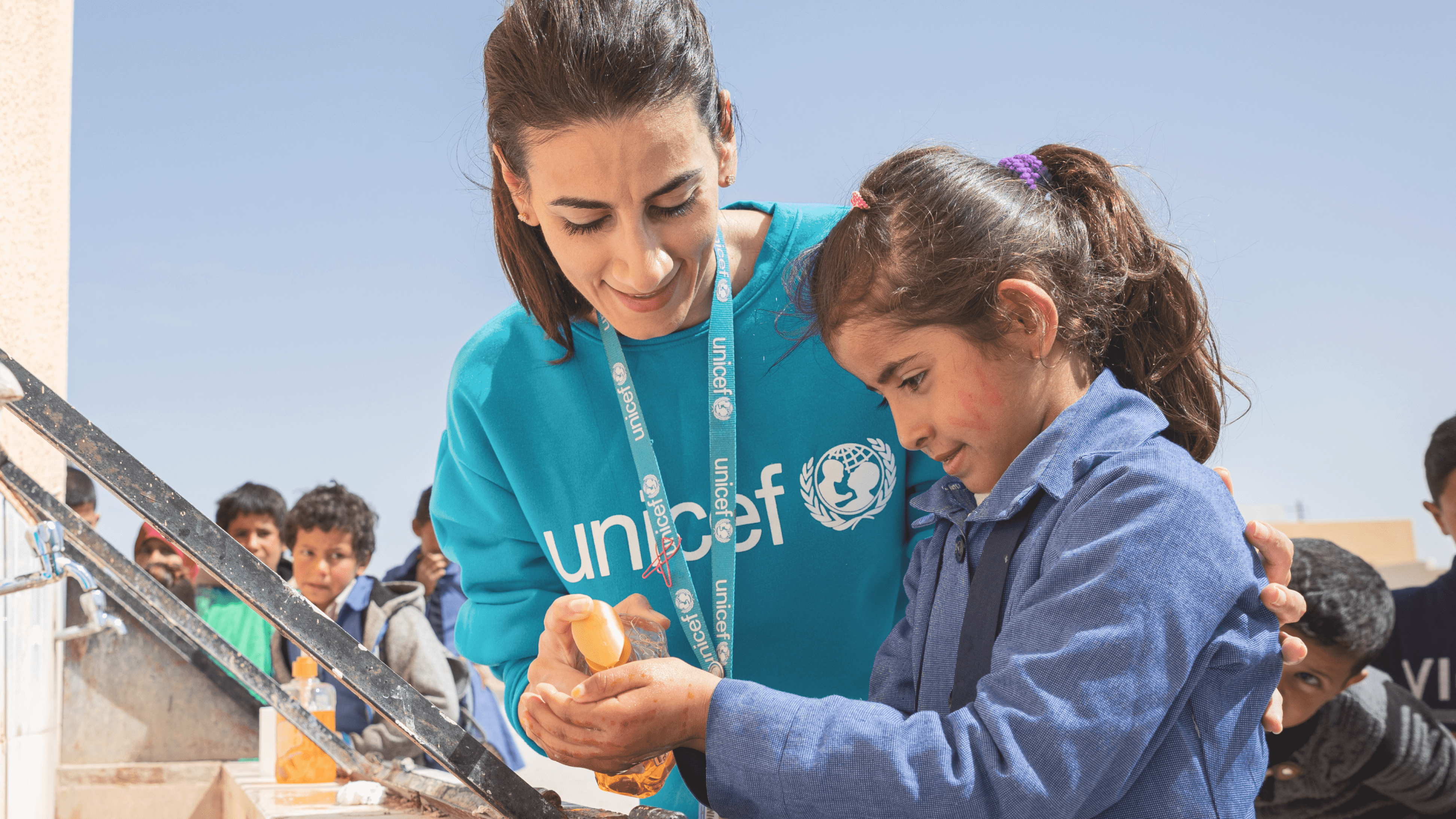 A female UNICEF worker with a child