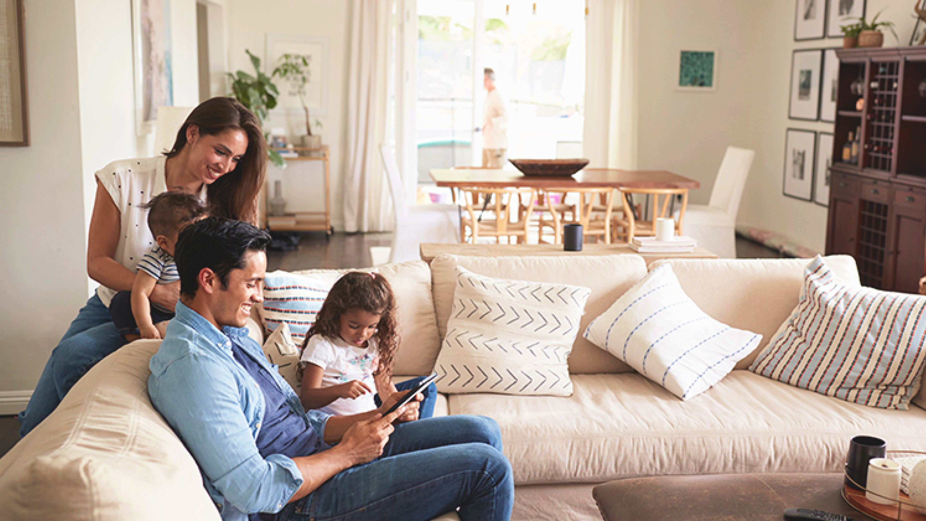 A family in a living room using the Wiser Virtual Smart Home app