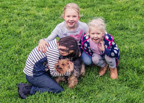 Three girls and a dog