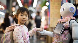 Girl holding robot's hand