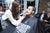 Specially trained POD barber shaving a man's beard