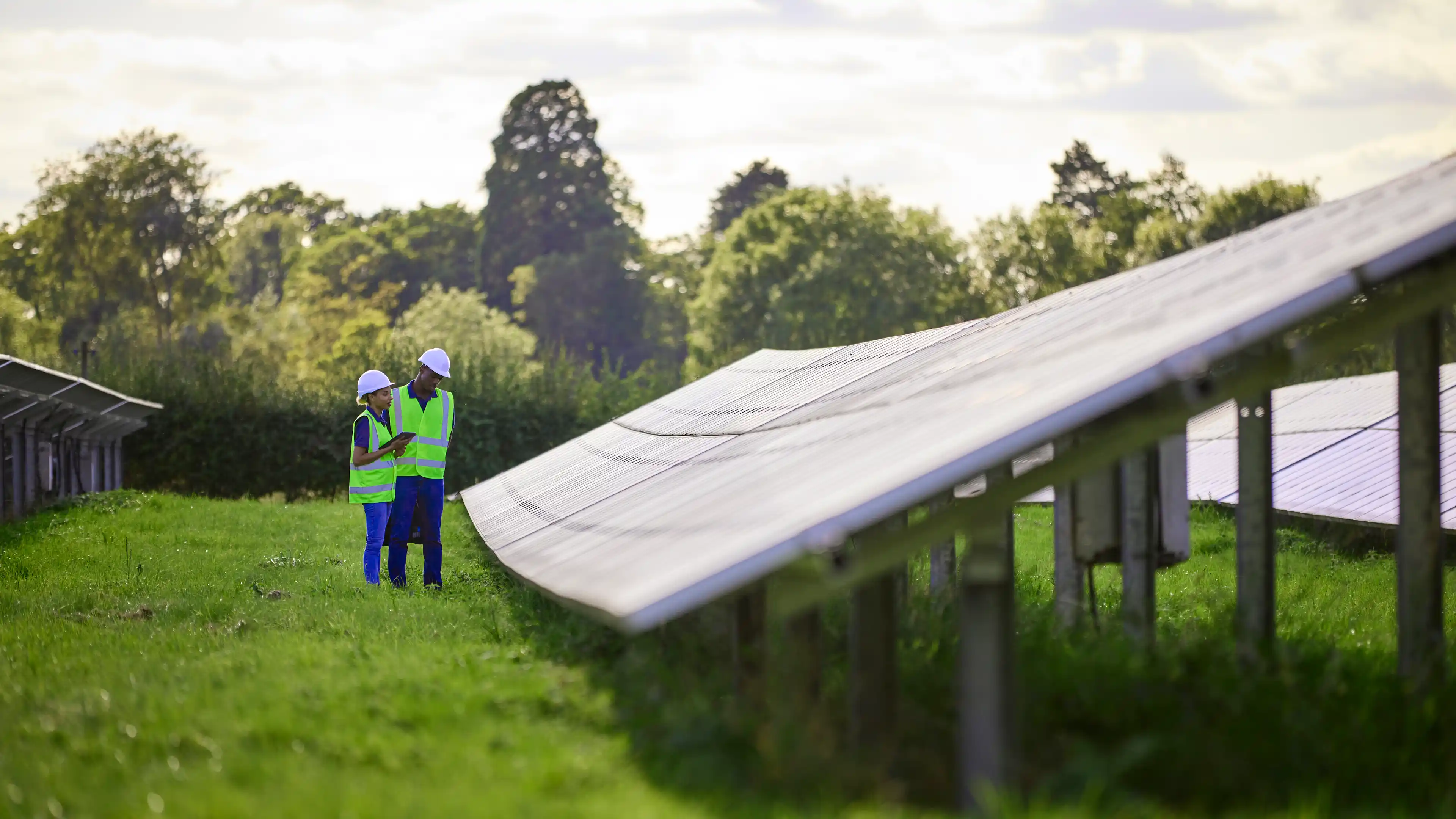 Teacher and apprentice inspecting solar paneling 