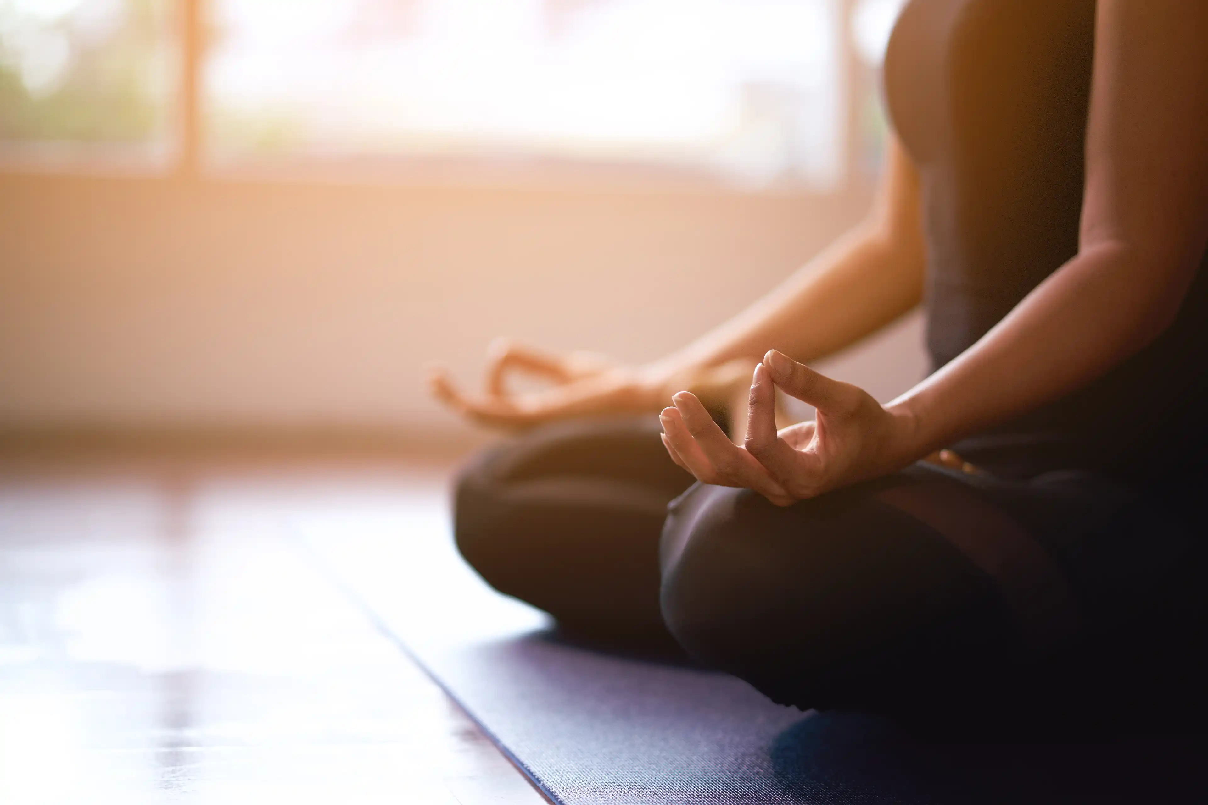 Person meditating on the floor 